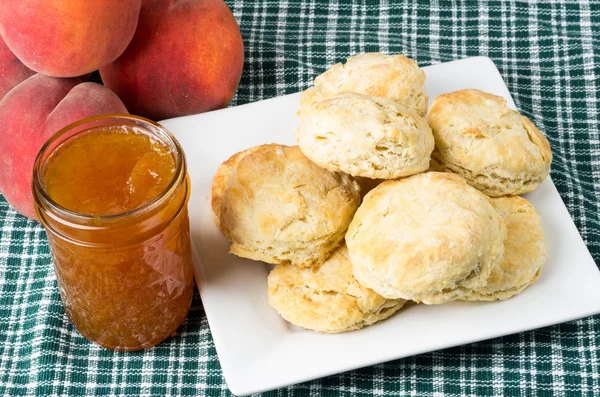 Plate of fresh biscuits with peach jam — Stock Photo, Image