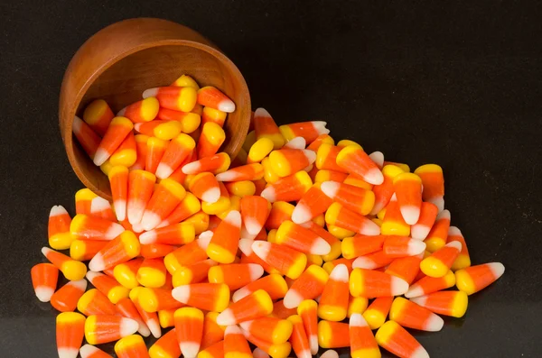 Candy corn and wooden bowl — Stock Photo, Image