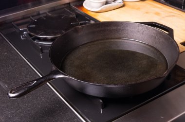 Cast iron skillet or fry pan on stove clipart