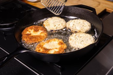 Frying eggplant in cast iron skillet clipart