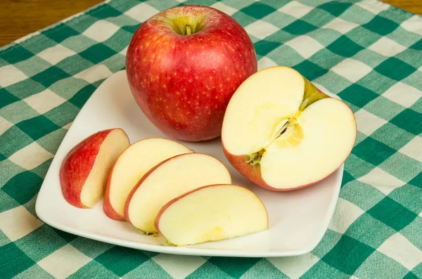 Pinova apple slices on white plate — Stock Photo, Image
