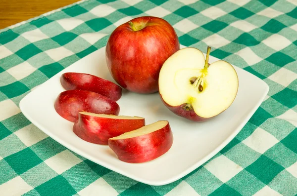 Empire apple slices on white plate — Stock Photo, Image