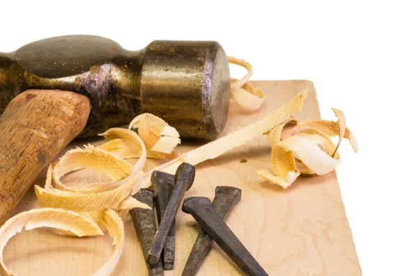 Hammer and nails on a wood board — Stock Photo, Image