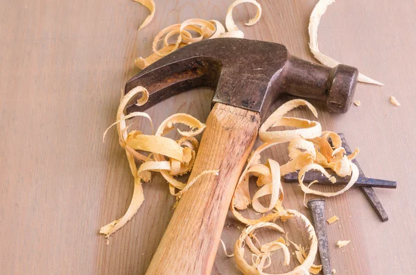 Hammer and nails on a wood board — Stock Photo, Image