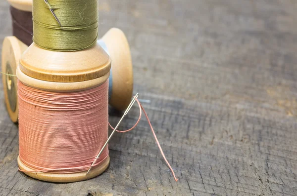 Spools of thread stacked with needle — Stock Photo, Image