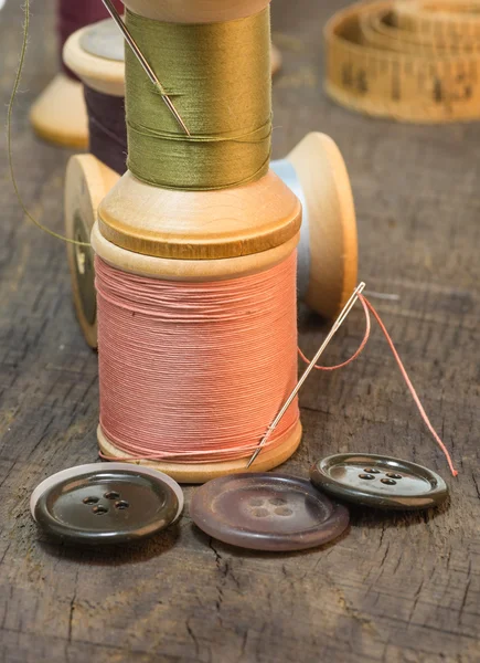 Needles and sewing thread with buttons — Stock Photo, Image