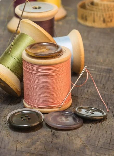 Buttons and needles with sewing thread — Stock Photo, Image
