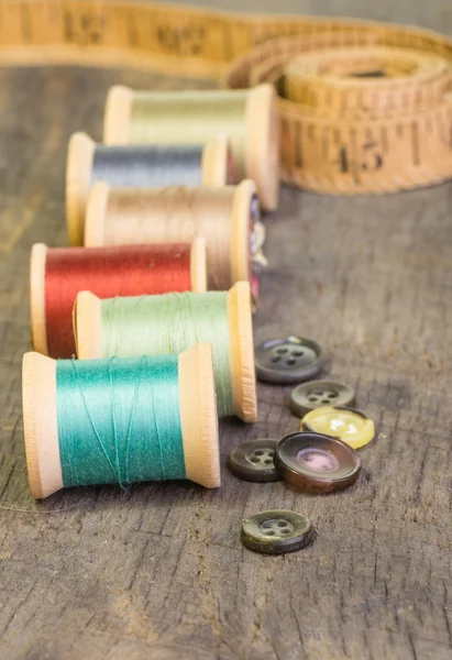 Buttons and measuring tape with thread — Stock Photo, Image