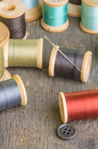 Spools of sewing thread with needle — Stock Photo, Image