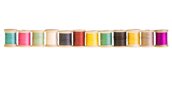 Row of thread spools isolated — Stock Photo, Image