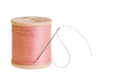 Spool of pink thread with needle clipart