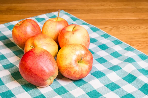 Gala apples on checked cloth — Stock Photo, Image