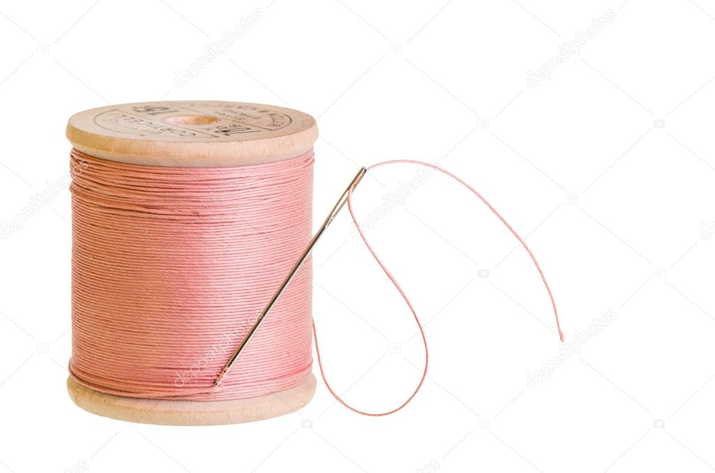 Spool of pink thread with needle Stock Photo by ©zigzagmtart 20786881