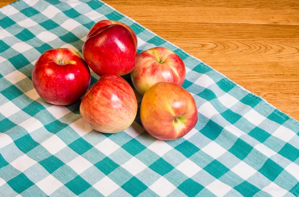 Fresh red apples on checked cloth — Stock Photo, Image