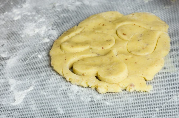 Raw dough being cut into shapes — Stock Photo, Image