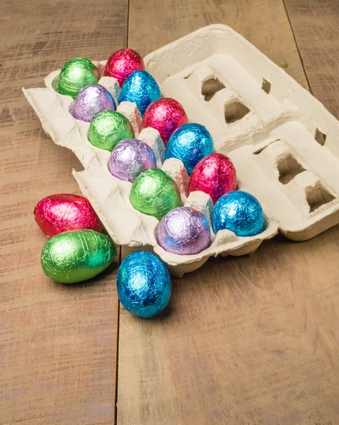 Colorful foiled eggs in container
