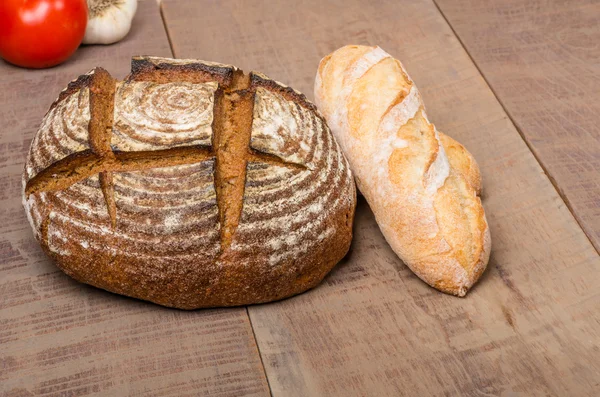 Loaf of fresh rye bread on a table — Stock Photo, Image