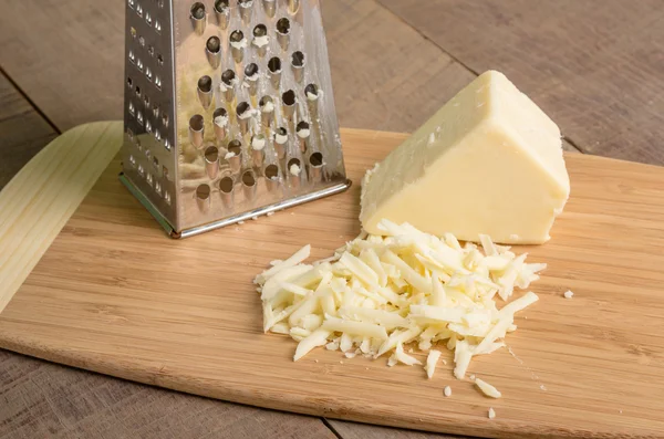 Parmesan cheese grated on a cutting board — Stock Photo, Image