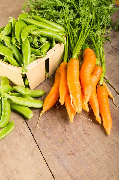 Fresh green peas and carrots — Stock Photo, Image