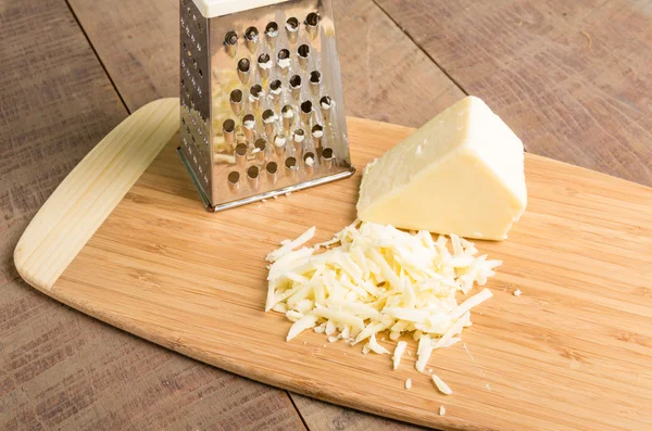Parmesan cheese grated on a cutting board — Stock Photo, Image