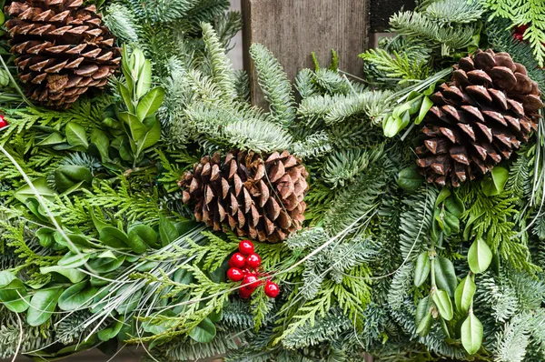 Holiday wreath of evergreens and cones — Stock Photo, Image