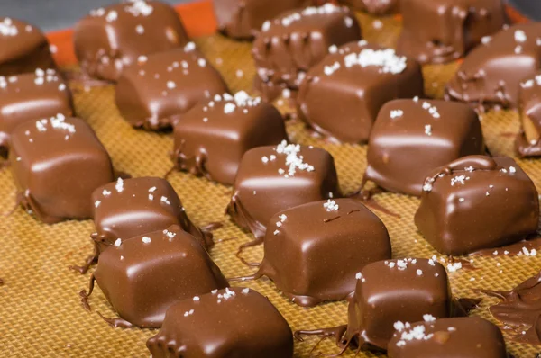 Chocolate coated caramel candy cubes — Stock Photo, Image