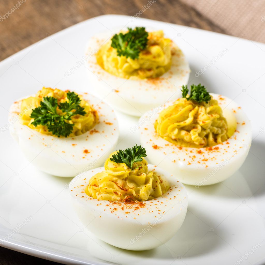 Deviled eggs garnished with parsley and paprika