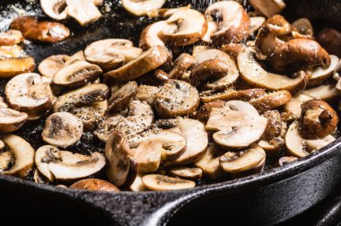 Sauteing sliced mushrooms in a skillet clipart