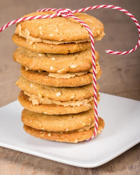 Stack of filled cookies tied with string — Stock Photo, Image