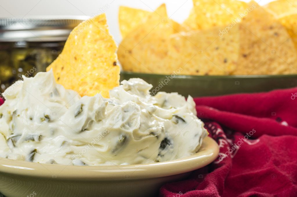Nacho chips with cream cheese dip Stock Photo by ©zigzagmtart 43119723