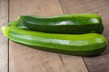 Zucchini squash on wooden table clipart