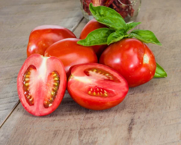 Fresh red paste tomatoes with jar — Stock Photo, Image