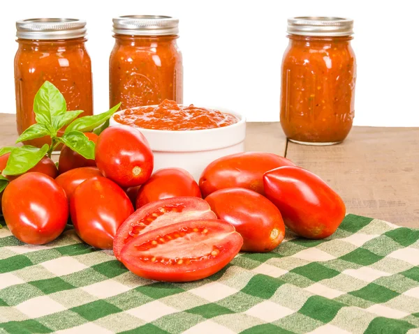 Jars of sauce with paste tomatoes and basil — Stock Photo, Image
