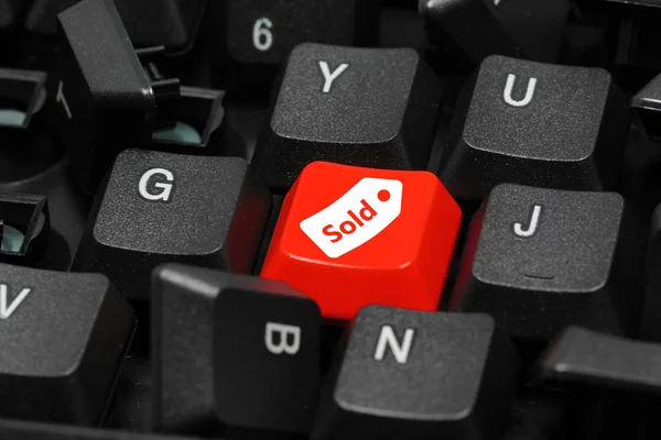 Sold icon on keyboard showing business or finance concept — Stock Photo, Image