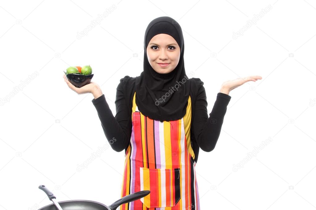 Muslim woman smiling happy presenting with open hand palm