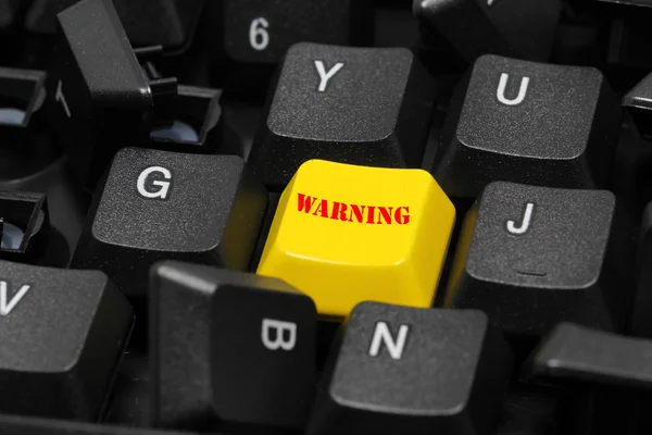 Warning word on yellow and black keyboard button — Stock Photo, Image