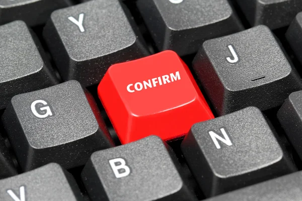 Confirm word on red and black keyboard button — Stock Photo, Image