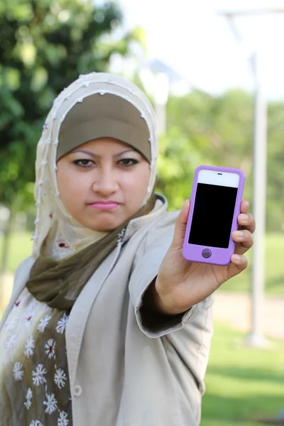 Young asian muslim girl angry with handphone text space — Stock Photo, Image