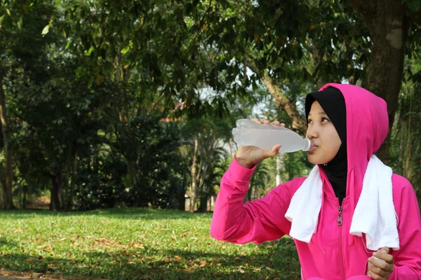 Bir şişe su içki dinlenme bir çok Müslüman kadın atlet — Stok fotoğraf