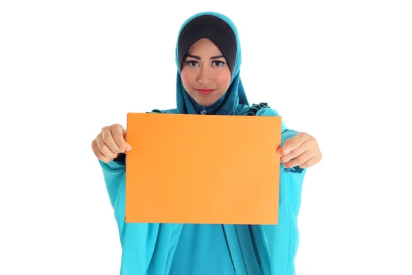 Schöne junge muslimische Frau posiert und hält ein leeres Papier — Stockfoto