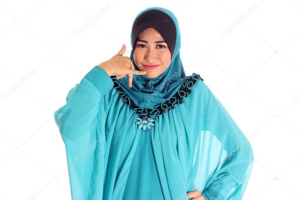 Young happy smiling muslim woman with call me gesture, isolated