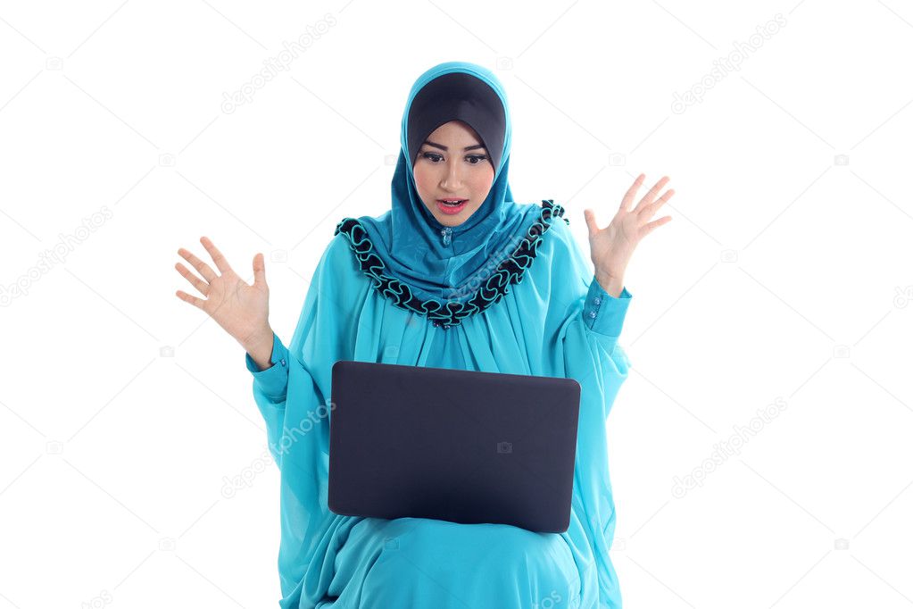 Portrait of a beautiful young muslim woman working on laptop isolated on white