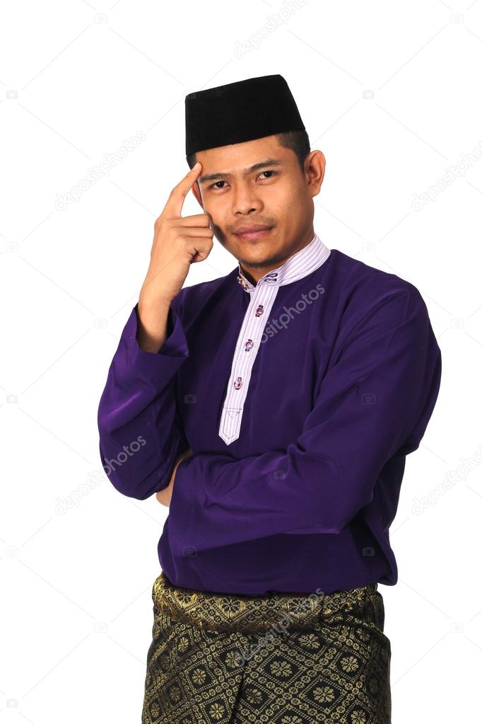 Asian muslim male with traditional Malay costume in thinking