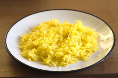 Zarda yellow saffron rice dessert on plate clipart