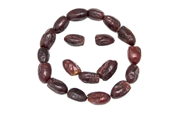 Date secche smiley su sfondo bianco isolato — Foto Stock