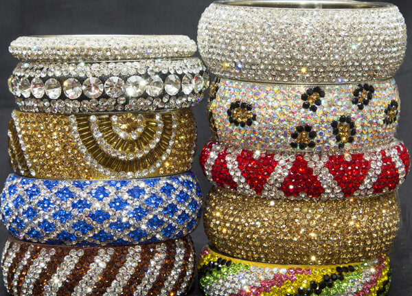Crystal stones metal bangles set in a pile