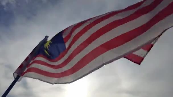 马来西亚国旗在有太阳背景的天空飘扬 — 图库视频影像