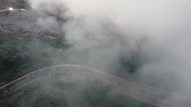 Aerial view smoke release from open burn at rubbish dump site