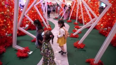 Georgetown, Penang, Malezya - 26 Aralık 2021: Yüzü maskeli çocuklar sahte karla oynuyor