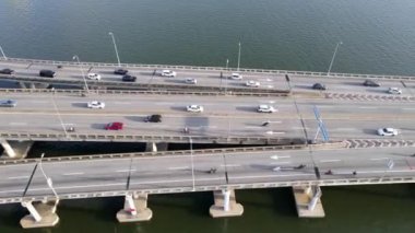 Georgetown, Penang, Malaysia - Nov 01 2021: Aerial look down car traffic cross the sea in morning sun light